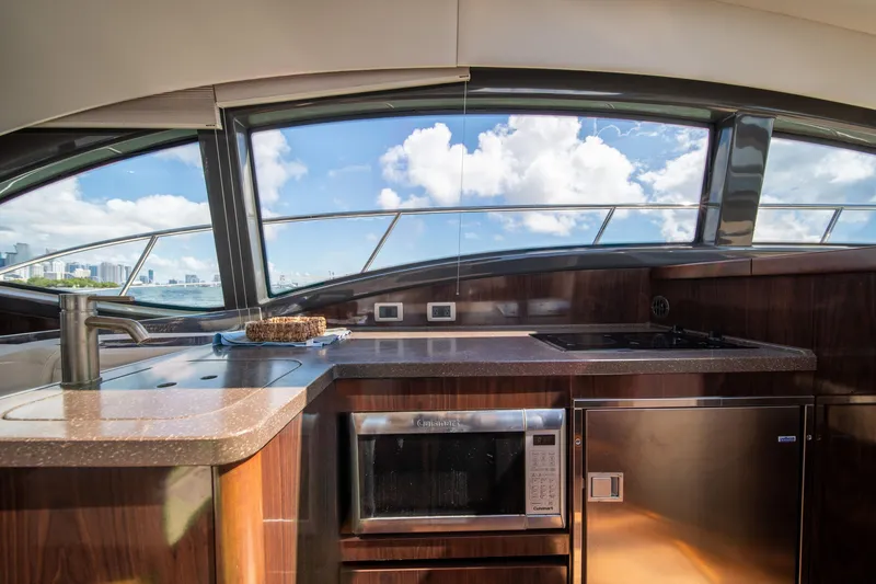 Slide: The Image of Luxurious interior of 2016 Sea Ray 400 Sundancer yacht with modern kitchen amenities. - 16