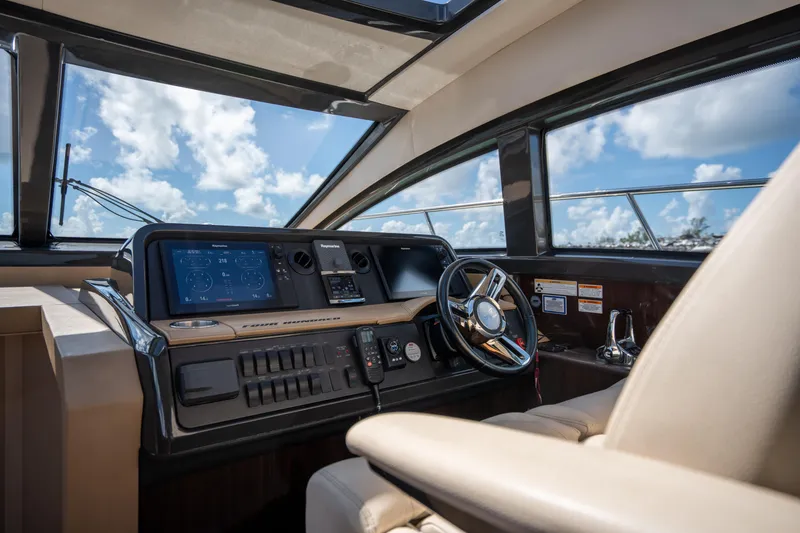 Slide: The Image of Helm of 2016 Sea Ray 400 Sundancer yacht with modern navigation controls. - 18