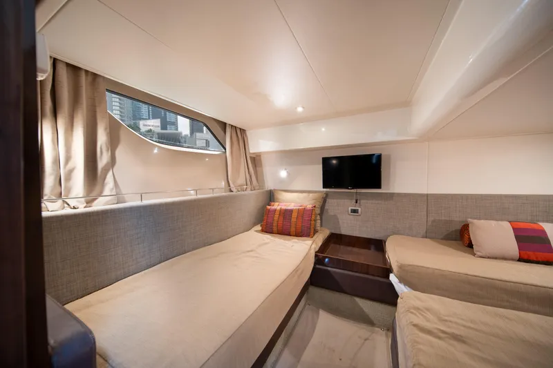 Slide: The Image of Interior cabin of 2016 Sea Ray 400 Sundancer yacht with twin beds and TV. - 29