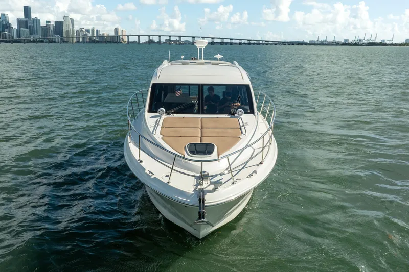 Slide: The Image of 2016 Sea Ray 400 Sundancer yacht cruising near city skyline and bridge. - 6