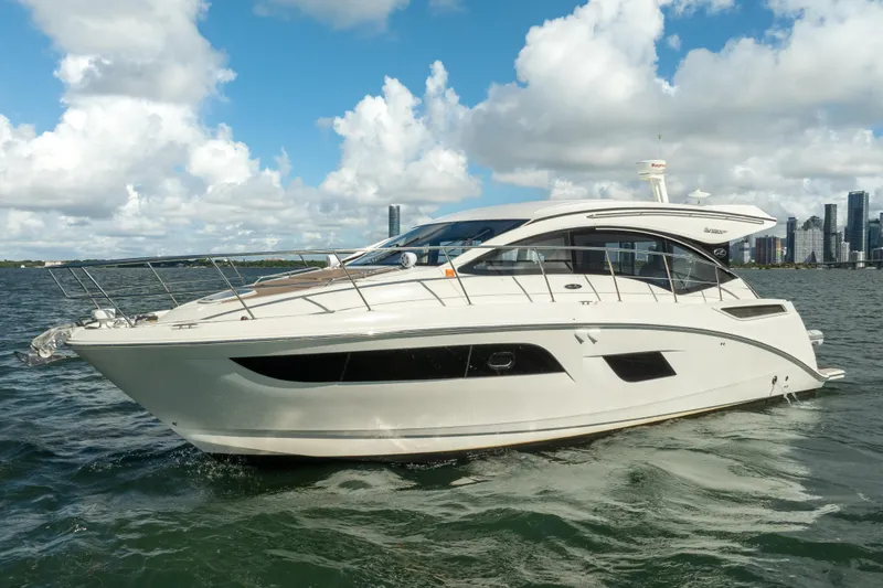 Slide: The Image of 2016 Sea Ray 400 Sundancer yacht on water with city skyline background. - 7