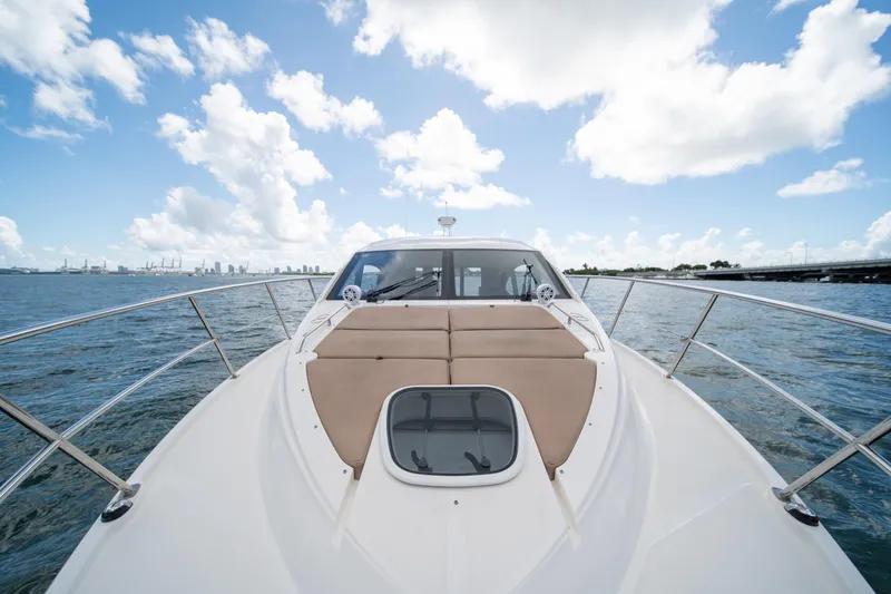 Slide: The Image of 2016 Sea Ray 400 Sundancer yacht on open water under a bright blue sky. - 8