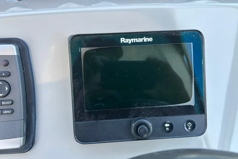 Slide: The Image of Raymarine navigation system on 2011 Bayliner 285 Cruiser dashboard. - 12