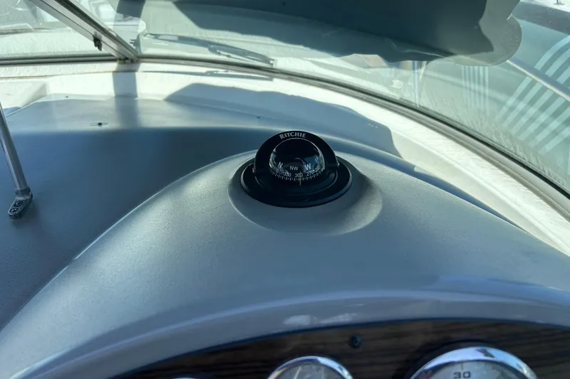 Slide: The Image of Dashboard compass on 2011 Bayliner 285 Cruiser boat, featuring Ritchie navigation instrument. - 13