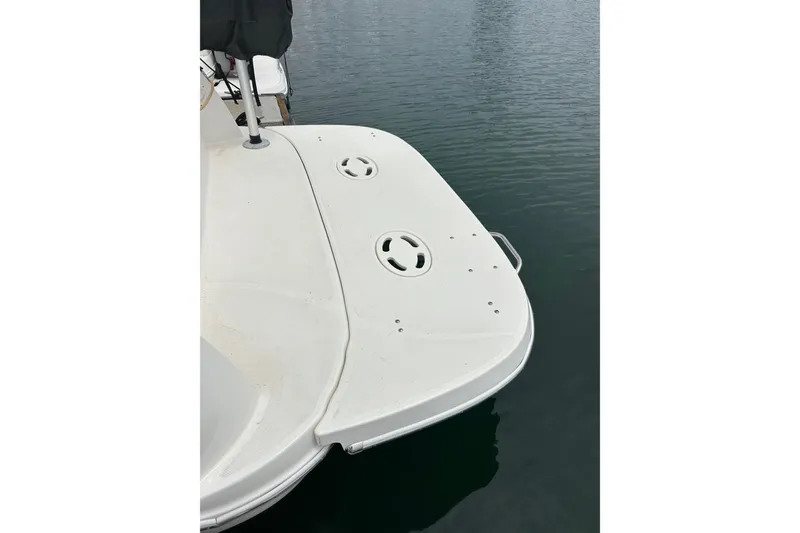 Slide: The Image of 2011 Bayliner 285 Cruiser swim platform on calm water. - 14