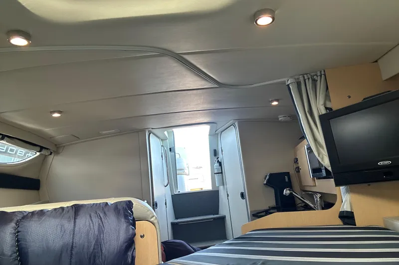 Slide: The Image of Interior of 2011 Bayliner 285 Cruiser with modern amenities and cozy design. - 16