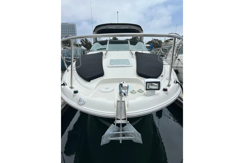 Slide: The Image of 2011 Bayliner 285 Cruiser boat docked, featuring a sleek design and spacious deck. - 2