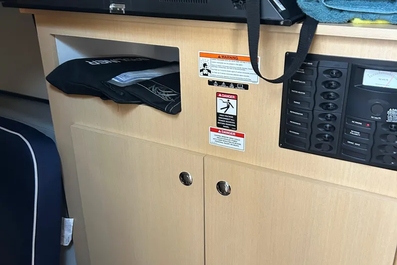 Slide: The Image of 2011 Bayliner 285 Cruiser interior with control panel and storage compartment. - 20