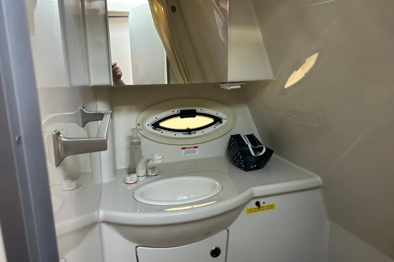 Slide: The Image of Bathroom interior of 2011 Bayliner 285 Cruiser with sink and mirror. - 24