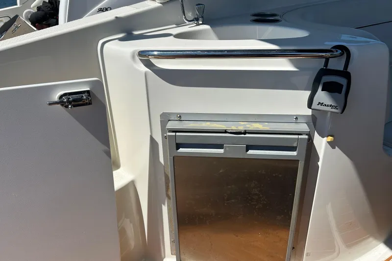 Slide: The Image of 2011 Bayliner 285 Cruiser interior with storage compartment and Master Lock. - 5