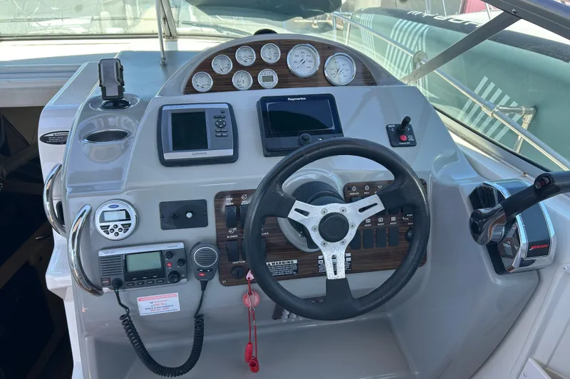 Slide: The Image of Control panel of a 2011 Bayliner 285 Cruiser with steering wheel and navigation instruments. - 6