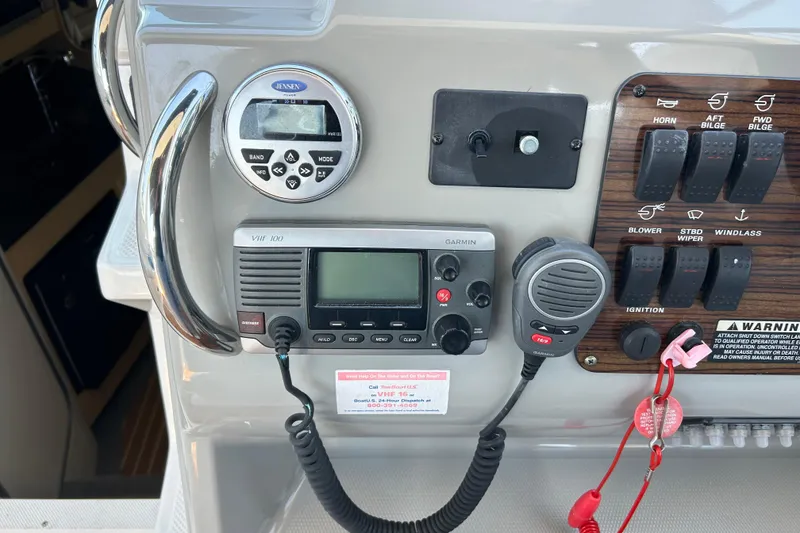 Slide: The Image of Control panel of a 2011 Bayliner 285 Cruiser with radio and switches. - 8