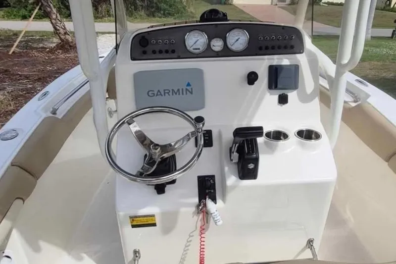 Slide: The Image of 2019 Pioneer 202 Islander boat dashboard with Garmin navigation and Suzuki controls. - 10