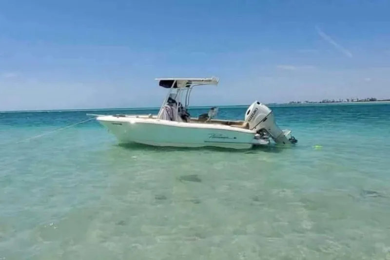 The Image of 2019 Pioneer 202 Islander boat anchored in clear turquoise water. - 2