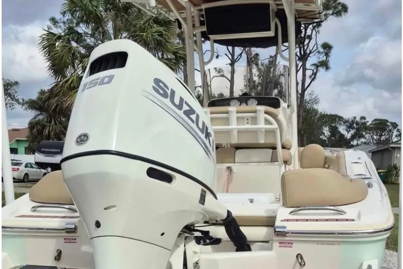 Slide: The Image of 2019 Pioneer 202 Islander boat with Suzuki 150 outboard motor, parked outdoors. - 7