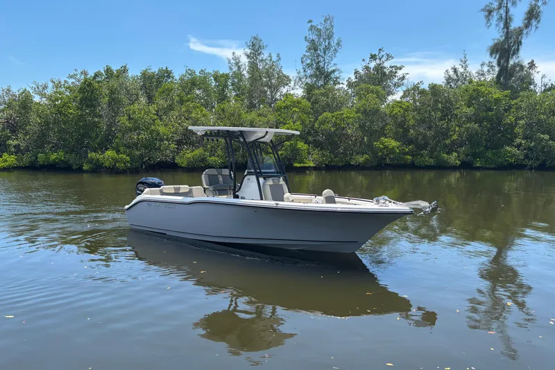 The Image of 2026 Key West 239 FS boat on calm water, surrounded by lush greenery. - 0
