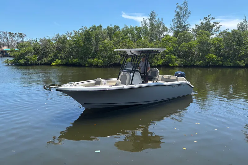 Slide: The Image of 2026 Key West 239 FS boat on calm water, surrounded by lush greenery. - 3