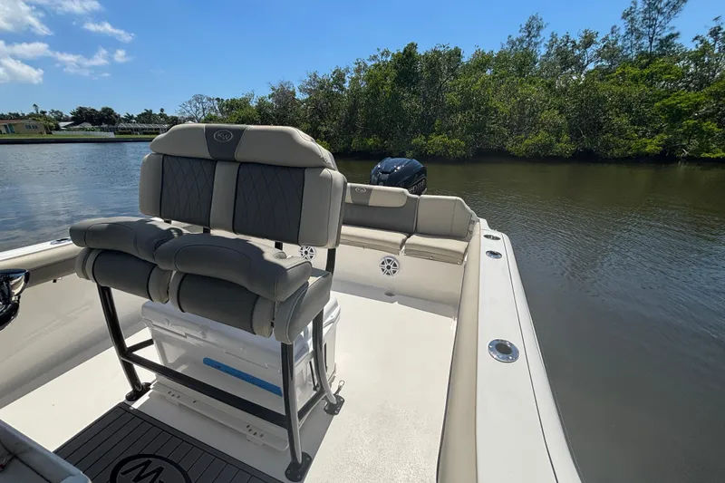 Slide: The Image of 2026 Key West 239 FS boat interior with seating, on a calm river. - 8