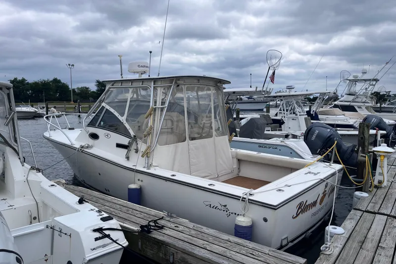 The Image of 2002 Albemarle 28 Express boat docked at marina under cloudy skies. - 0