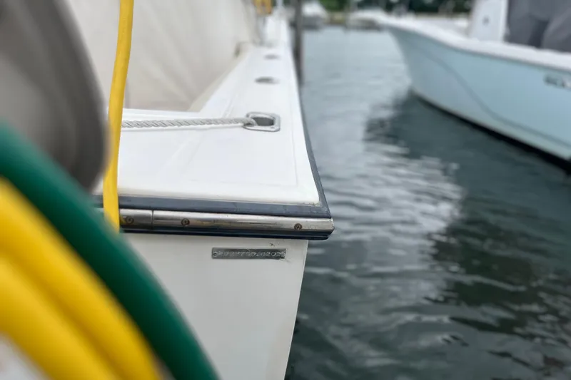 Slide: The Image of Close-up of a 2002 Albemarle 28 Express boat docked by the water. - 16