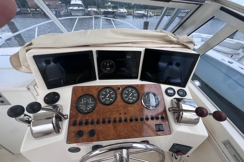 Slide: The Image of 2002 Albemarle 28 Express helm with gauges, controls, and navigation screens. - 17