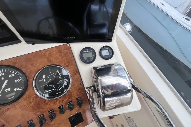 Slide: The Image of 2002 Albemarle 28 Express boat dashboard with gauges and controls. - 19