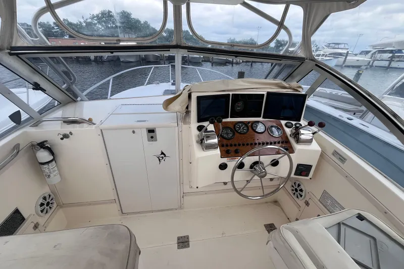 Slide: The Image of 2002 Albemarle 28 Express boat cockpit with steering wheel and control panel. - 21