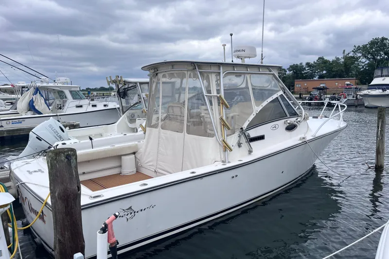 Slide: The Image of 2002 Albemarle 28 Express boat docked in a marina, featuring a white exterior. - 5