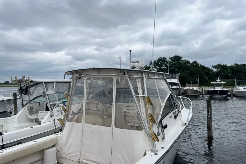 Slide: The Image of 2002 Albemarle 28 Express boat docked under cloudy skies. - 6