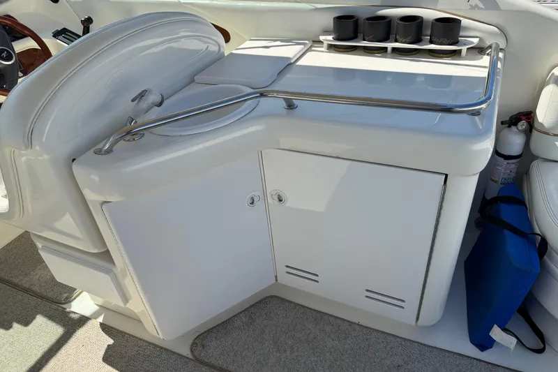 Slide: The Image of 1998 Sea Ray 280 Sun Sport boat interior with sink, storage, and cup holders. - 10