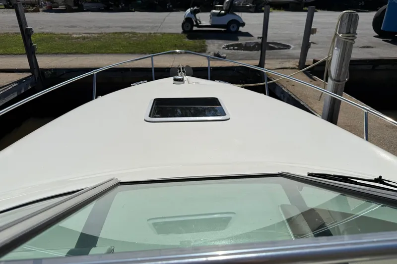 Slide: The Image of 1998 Sea Ray 280 Sun Sport boat docked, view from the bow with windshield and hatch. - 12