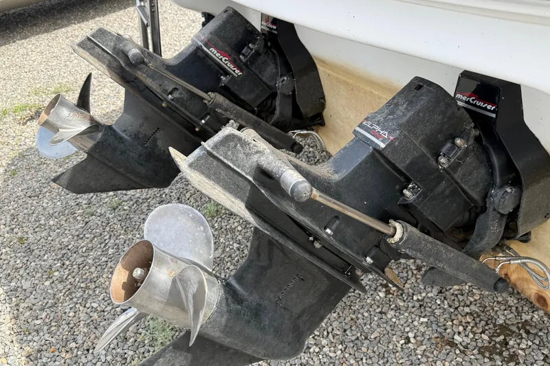 Slide: The Image of 1998 Sea Ray 280 Sun Sport boat with dual MerCruiser Alpha One outdrives on gravel. - 13