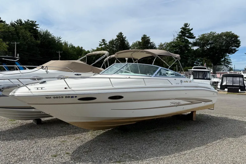 Slide: The Image of 1998 Sea Ray 280 Sun Sport boat on display in a marina setting. - 2