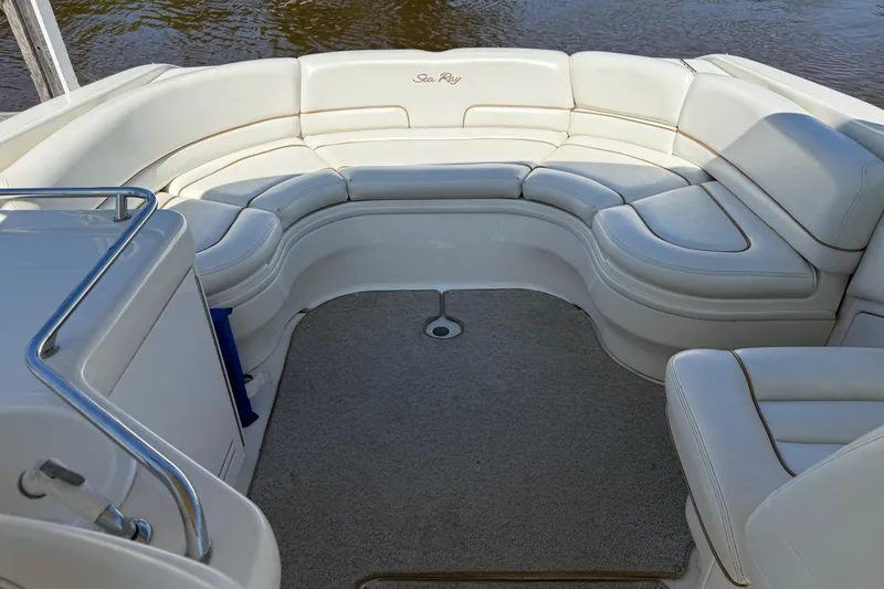 Slide: The Image of 1998 Sea Ray 280 Sun Sport boat interior with white cushioned seating and carpeted floor. - 8