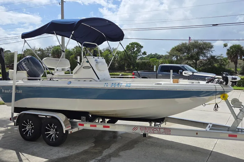 The Image of 2006 NauticStar 1900 Nautic Bay boat on trailer with canopy and Yamaha motor. - 0