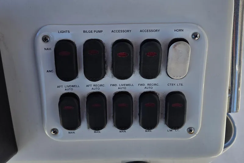 Slide: The Image of Control panel of a 2006 NauticStar 1900 Nautic Bay boat with labeled switches. - 12