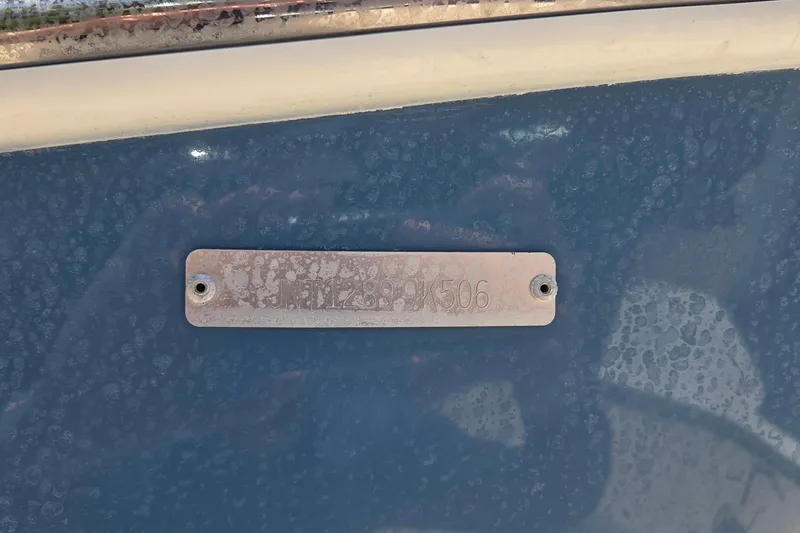 Slide: The Image of 2006 NauticStar 1900 Nautic Bay boat identification plate on blue hull. - 13