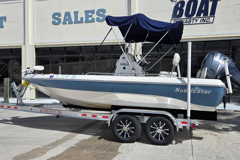 Slide: The Image of 2006 NauticStar 1900 Nautic Bay boat on trailer, parked outside sales building. - 2