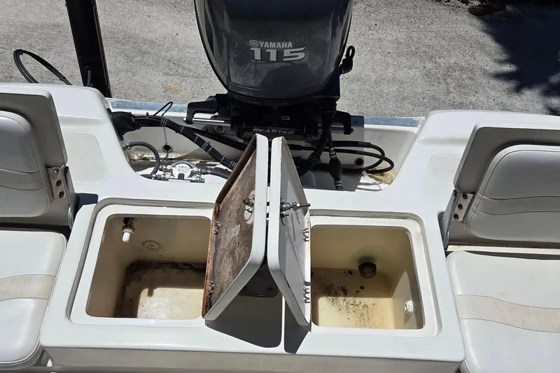 Slide: The Image of 2006 NauticStar 1900 Nautic Bay boat with Yamaha 115 engine and open storage compartments. - 9