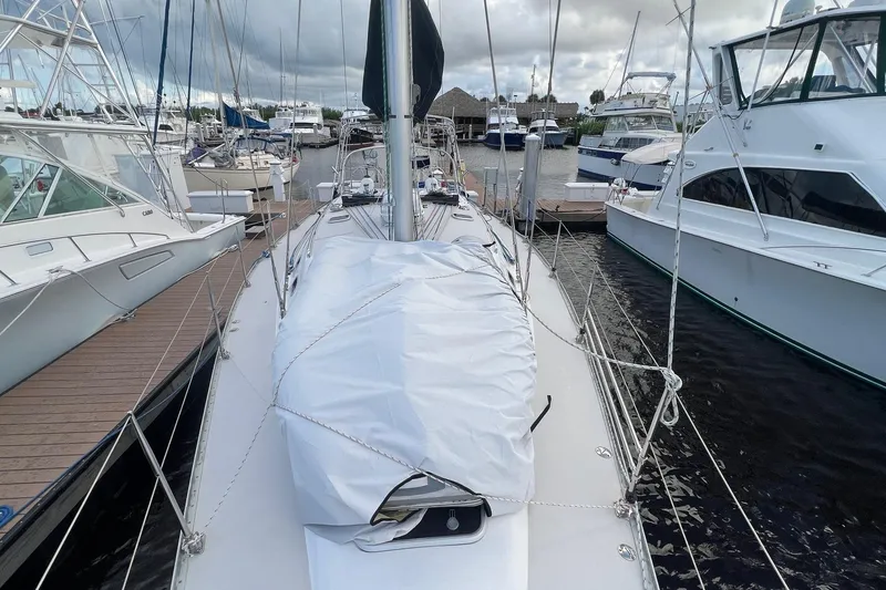 Slide: The Image of Sailboat Catalina 470, 1999 model, docked at marina with other boats. - 13