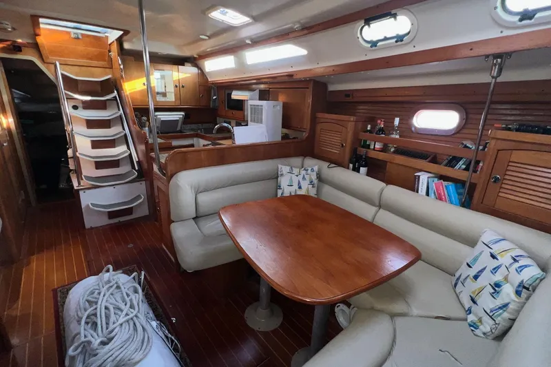 Slide: The Image of Interior of a 1999 Catalina 470 sailboat with cozy seating and wooden finishes. - 19