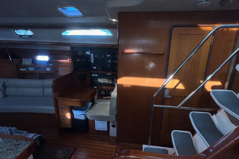 Slide: The Image of Interior of a 1999 Catalina 470 yacht with wooden finishes and seating area. - 25