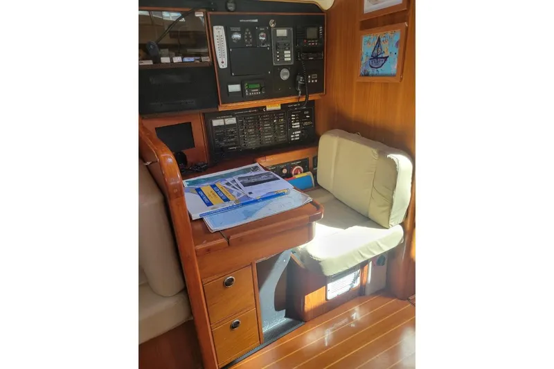 Slide: The Image of Navigation station inside 1999 Catalina 470 yacht with charts and instruments. - 27