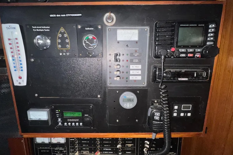 Slide: The Image of Control panel of a 1999 Catalina 470 yacht with various gauges and communication devices. - 29
