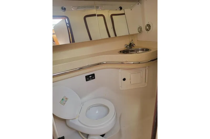 Slide: The Image of 1999 Catalina 470 yacht bathroom with toilet, sink, and mirror. - 39