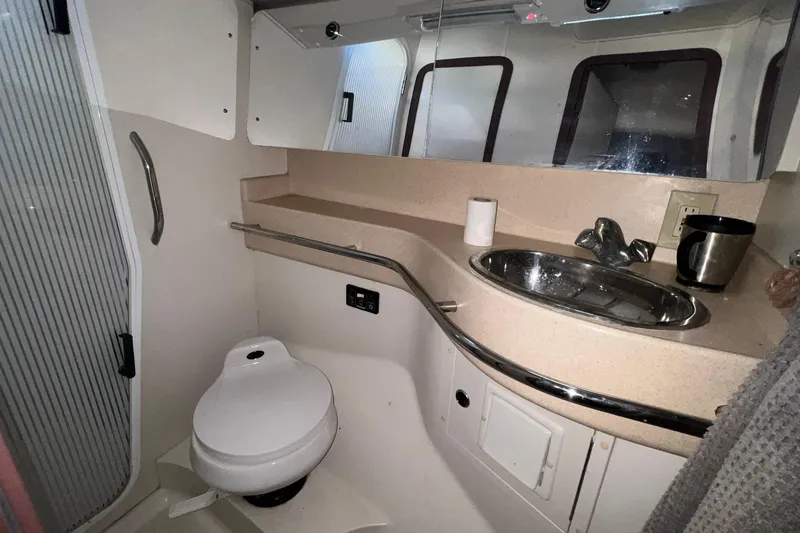 Slide: The Image of Bathroom interior of a 1999 Catalina 470 yacht, featuring sink and toilet. - 40