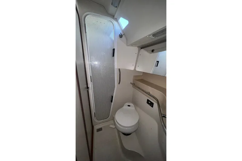 Slide: The Image of Bathroom interior of 1999 Catalina 470 yacht, featuring toilet and shower area. - 41