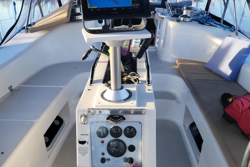 Slide: The Image of Cockpit of 1999 Catalina 470 sailboat with navigation equipment and seating area. - 7