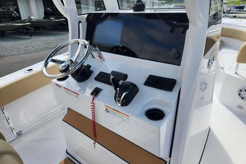 Slide: The Image of 2026 Sportsman Open 232 Center Console boat dashboard with steering wheel and controls. - 10