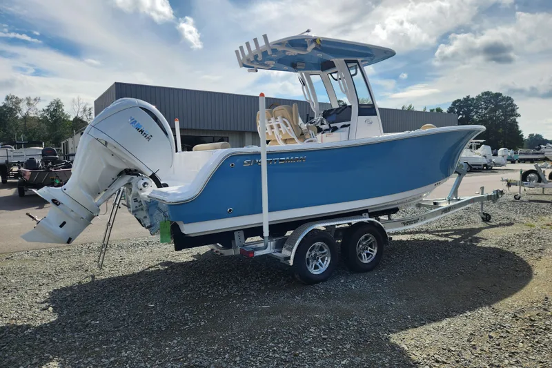 Slide: The Image of 2026 Sportsman Open 232 Center Console boat on trailer, featuring Yamaha outboard motor. - 2